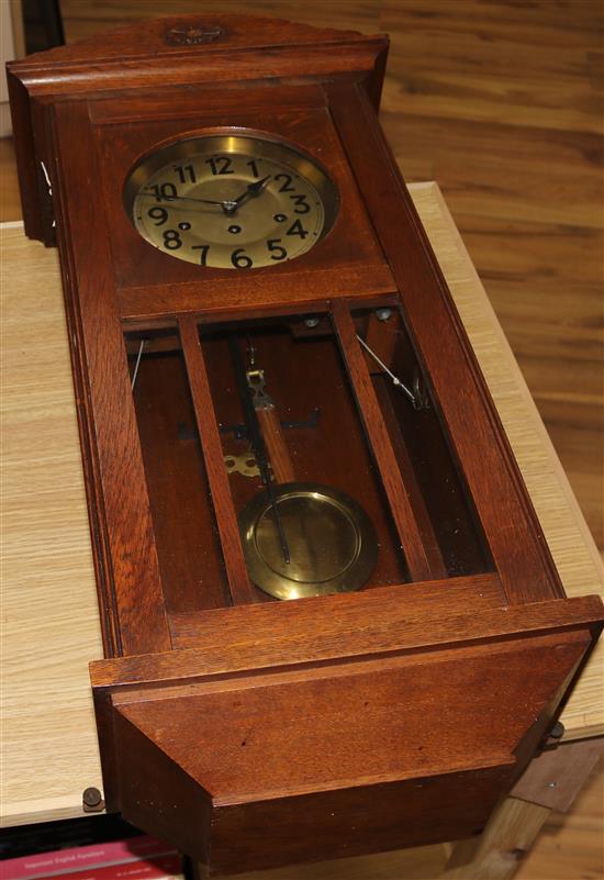 A 1930s oak wall clock